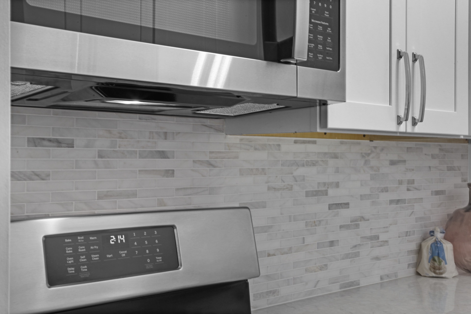 Custom kitchen with stone counters and paneled appliances
